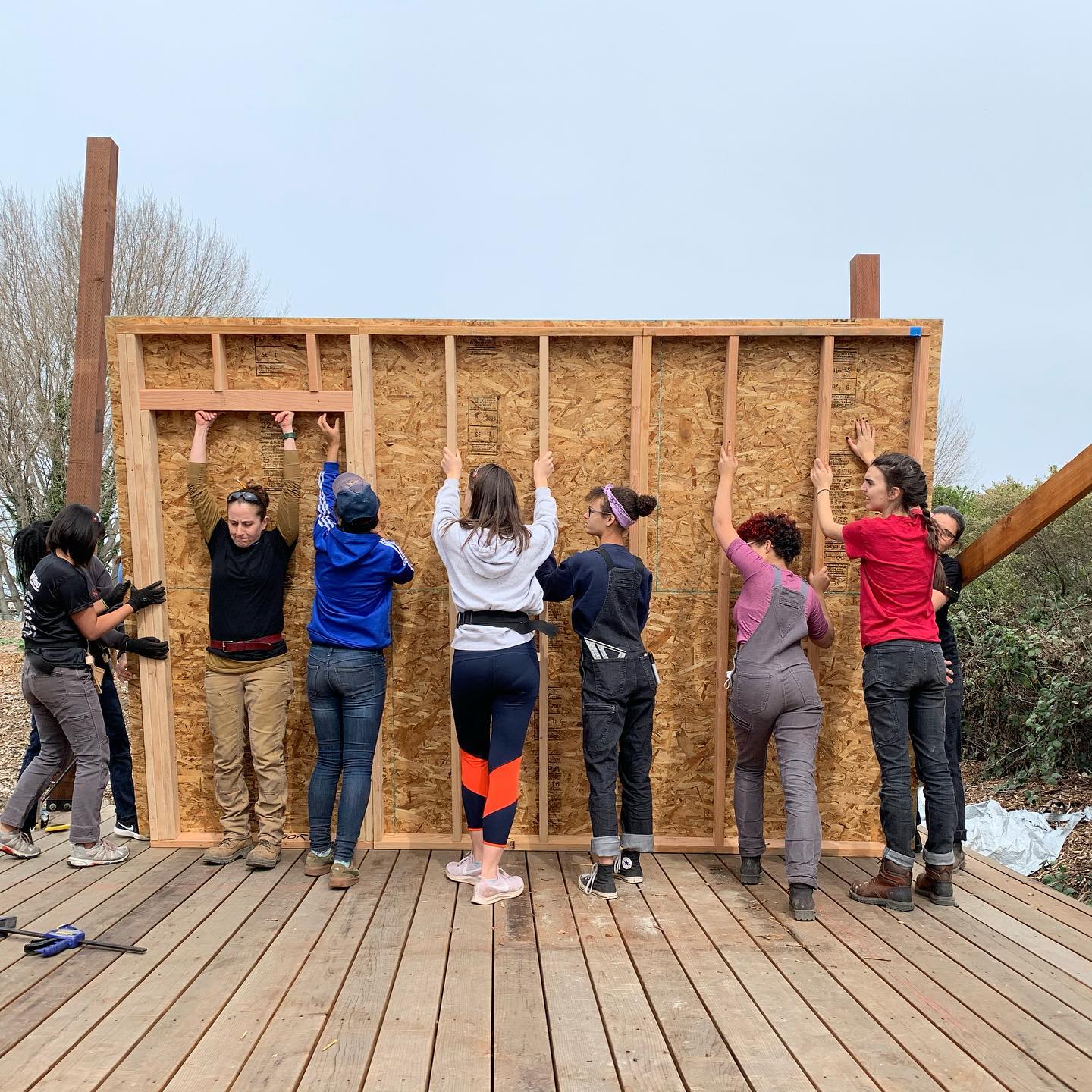 Girls Garage teen builders lift a wall