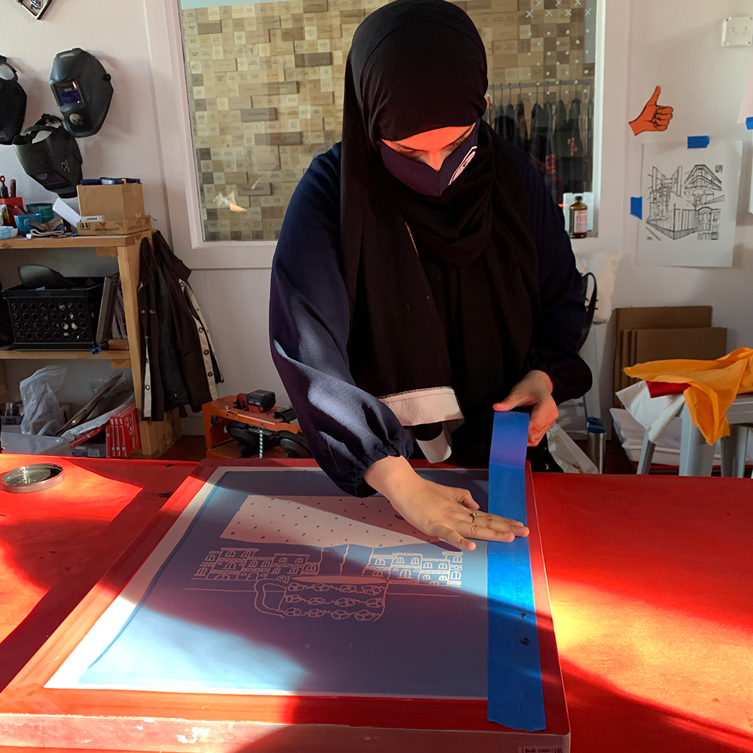Artist tapes off her screen print