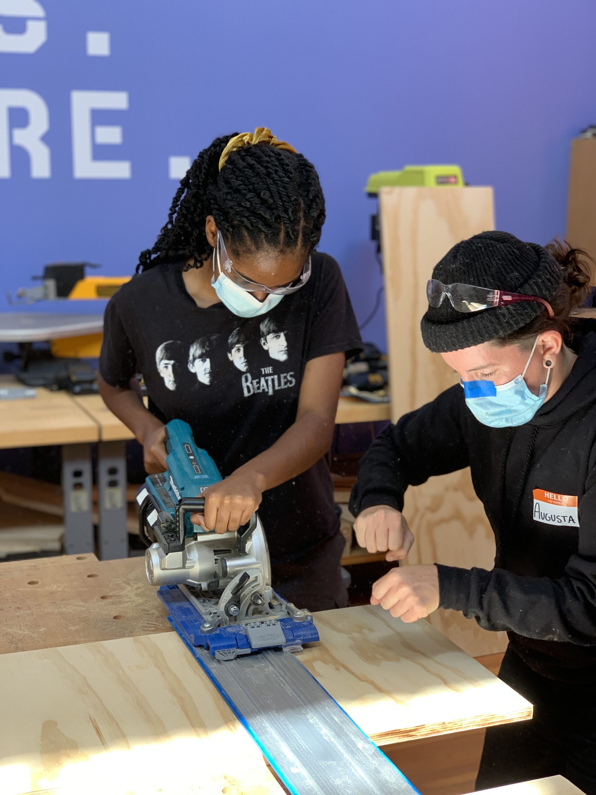Augusta Sitney demonstrates how to use the circular saw at Girls Garage