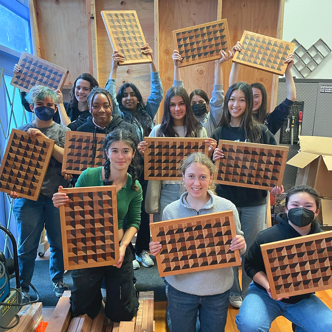 Advanced Design/Build students with optical illusion cutting boards