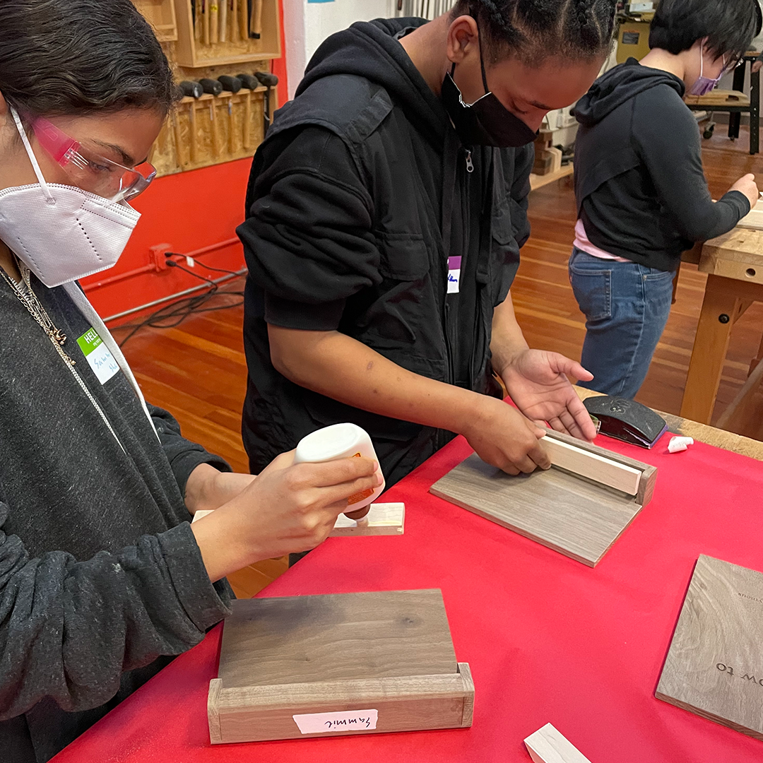 Students gluing spines onto cover