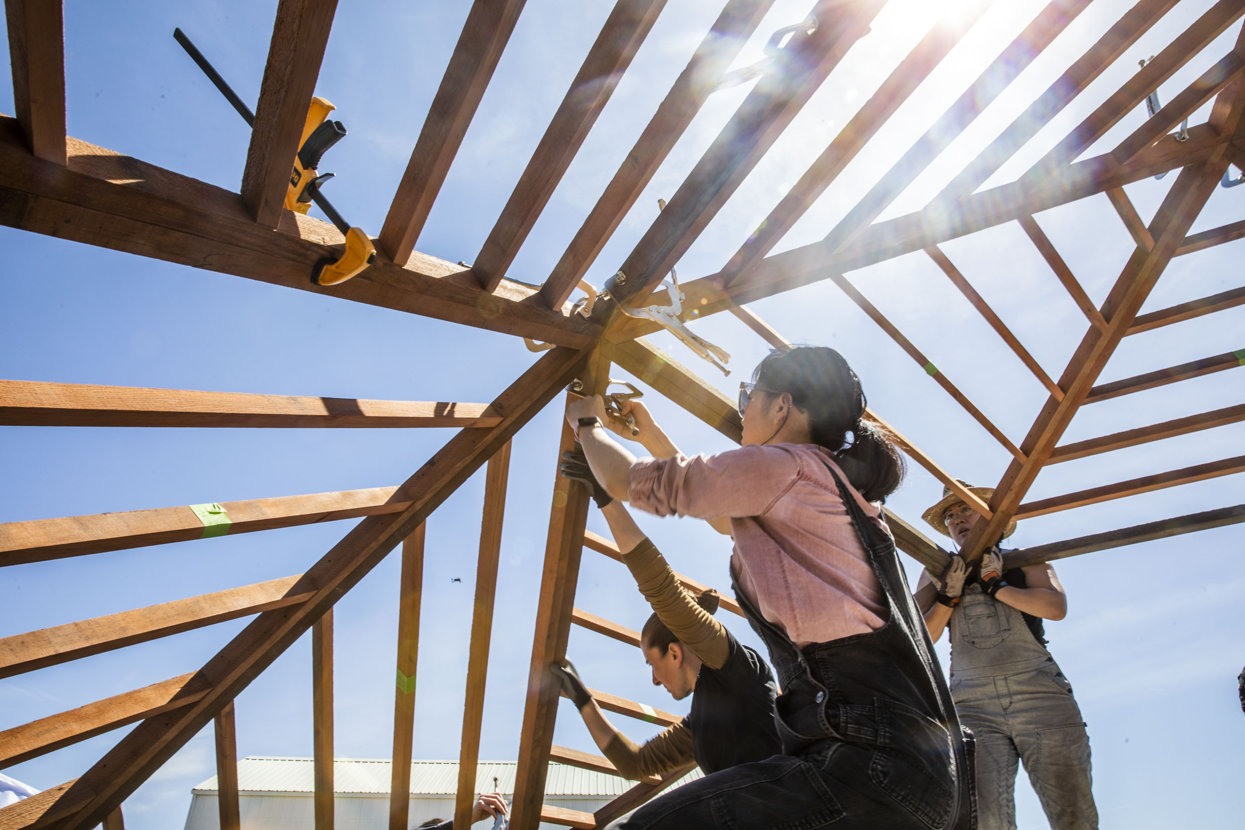 Action shot of student installing geodesic dome